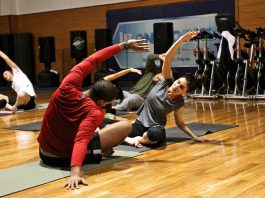 The image shows a woman exercising in a gym